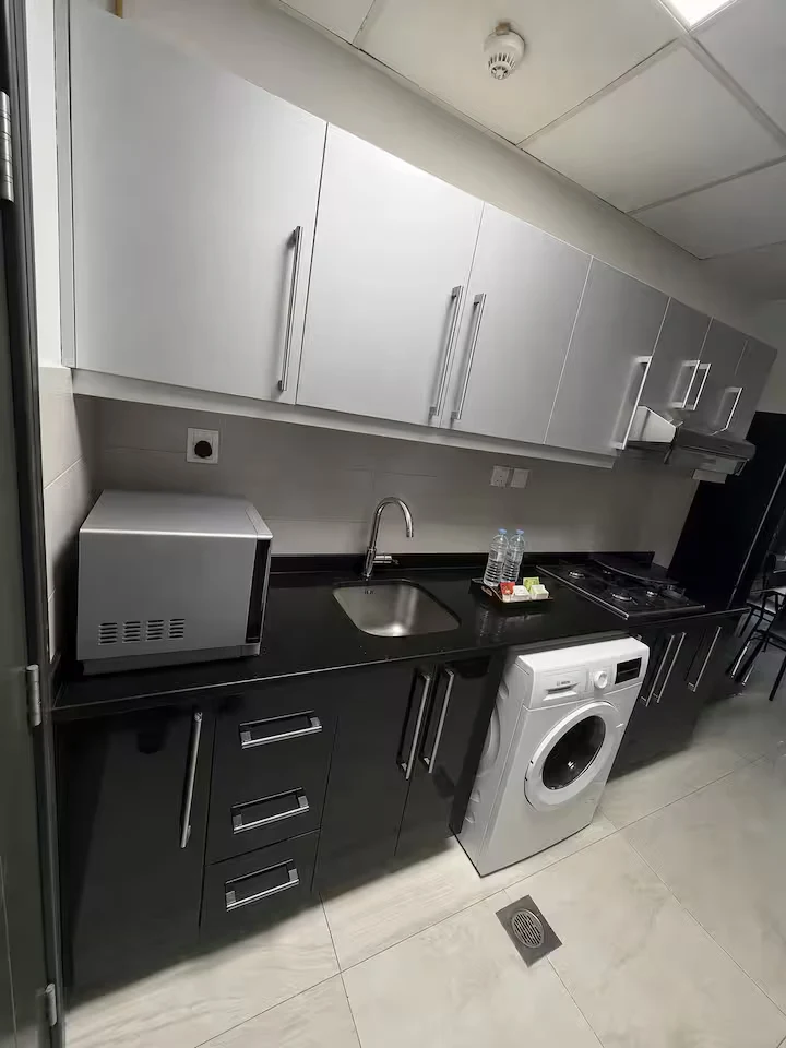 Kitchen with gas hob, microwave and washing machine